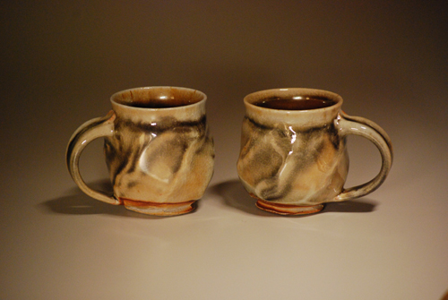 Two anagama-fired mugs with ash and flame variation
